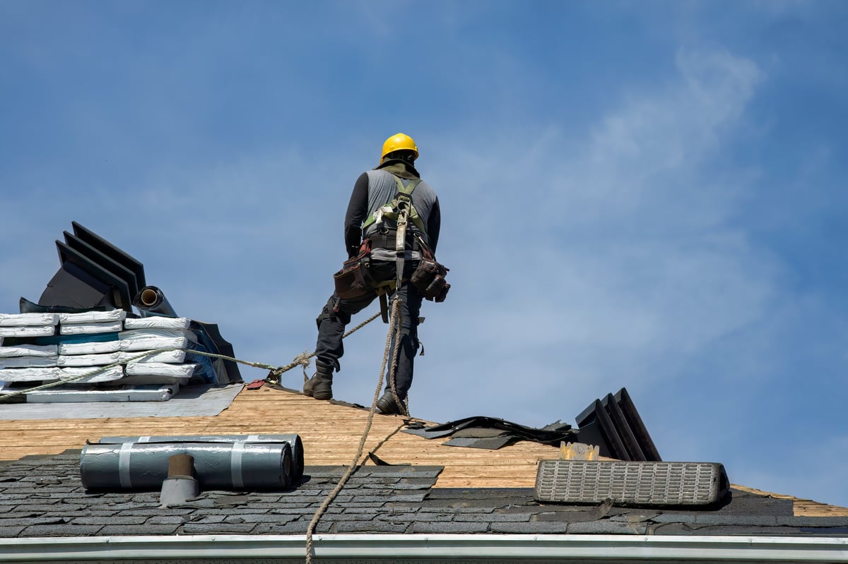 Roofing specialist installing roofing materials on a residential roof